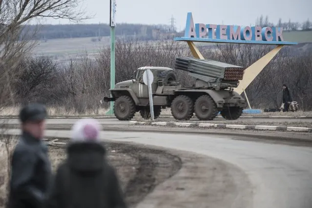 A Ukrainian multiple rocket launcher system BM-21 “Grad” is driven on a road near Artemivsk, eastern Ukraine, Thursday, February 5, 2015. (Photo by Evgeniy Maloletka/AP Photo)