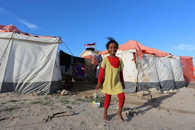 A Yemeni refugee girl walks from their shelter tent at a makeshift camp in Somalia's capital Mogadishu, December 16, 2015. (Photo by Feisal Omar/Reuters)