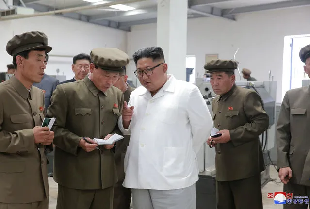 In this undated photo provided on Tuesday, July 17, 2018, by the North Korean government, North Korean leader Kim Jong Un, center, speaks during a visit to a machine factory in North Hamgyong Province, North Korea. State media say that Kim has harshly reprimanded local officials over a delayed construction project. Independent journalists were not given access to cover the event depicted in this image distributed by the North Korean government. The content of this image is as provided and cannot be independently verified. Korean language watermark on image as provided by source reads: “KCNA” which is the abbreviation for Korean Central News Agency. (Photo by Korean Central News Agency/Korea News Service via AP Photo)