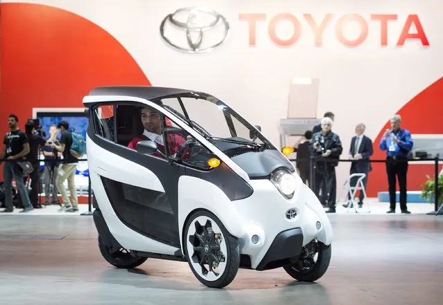 A man tests drives the Toyota i-Road at the 2015 Canadian International Auto Show in Toronto on Thursday, February 12, 2015. (Photo by Darren Calabrese/AP Photo/The Canadian Press)