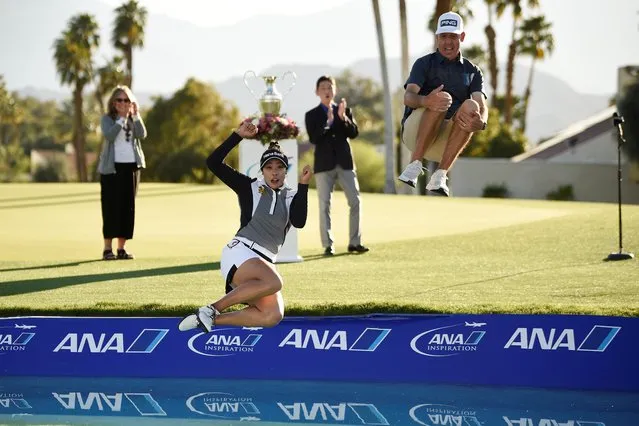 Thai golfer Patty Tavatanakit (front L) celebrates her ANA Inspiration victory by jumping into “Poppie's Pond” at Mission Hills Country Club in Rancho Mirage, California, on April 4, 2021. (Photo by Kelvin Kuo/USA TODAY Sports)