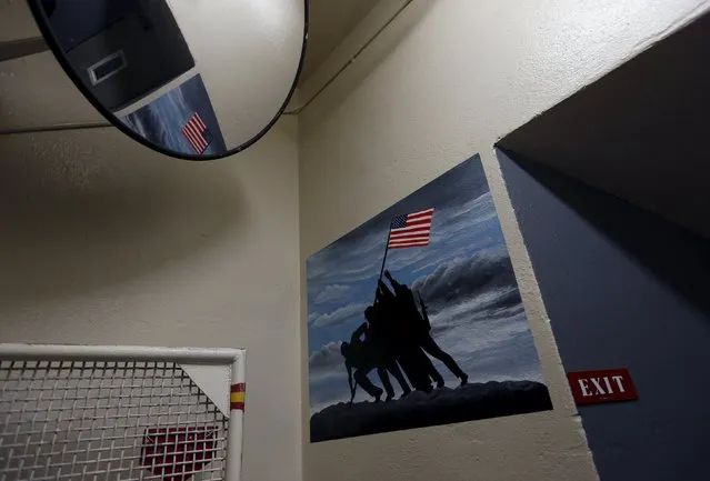 A painting of 'Raising the Flag on Iwo Jima' is seen at the end of a flight of stairs that leads to the Condemned Row at San Quentin State Prison during a media tour of California's Death Row in San Quentin, California December 29, 2015. (Photo by Stephen Lam/Reuters)