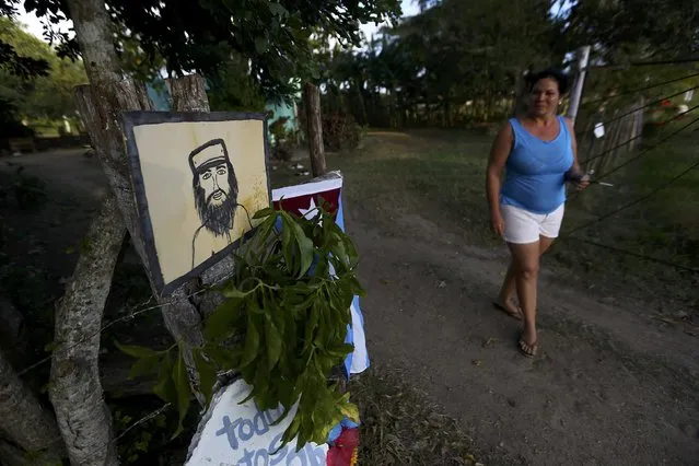 A woman walks near a drawing of Cuba's late President Fidel Castro in Camaguey, Cuba, November 30, 2016. (Photo by Ivan Alvarado/Reuters)