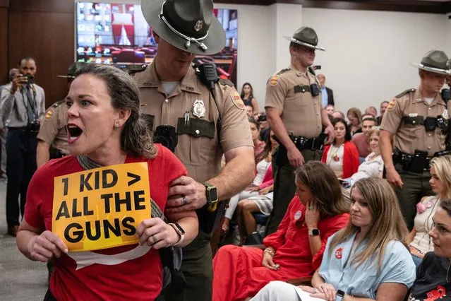 Allison Polidor is removed from a House Civil Justice Hearing for holding a sign on the second day of special session to discuss gun violence in the wake of the Covenant School shooting in Nashville, Tennessee, U.S., August 22, 2023. (Photo by Cheney Orr/Reuters)