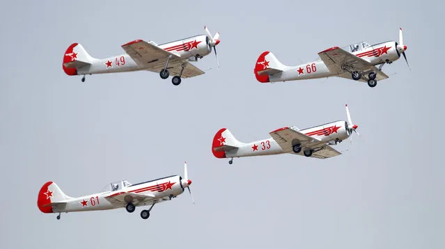 Russian aerobatic team Yakovlev fly in a formation on the second day of “Aero India 2015” at Yelahanka air base in Bangalore, India, Thursday, February 19, 2015. Aviation companies from around the world are participating in the five-day event which runs through Feb. 22. (Photo by Aijaz Rahi/AP Photo)