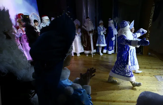 People dressed as Father Frost, the equivalent of Santa Claus, and Snow Maiden take part in the contest “Yolka-fest-2016” (Fir-festival-2016) in Minsk, Belarus December 9, 2016. (Photo by Vasily Fedosenko/Reuters)