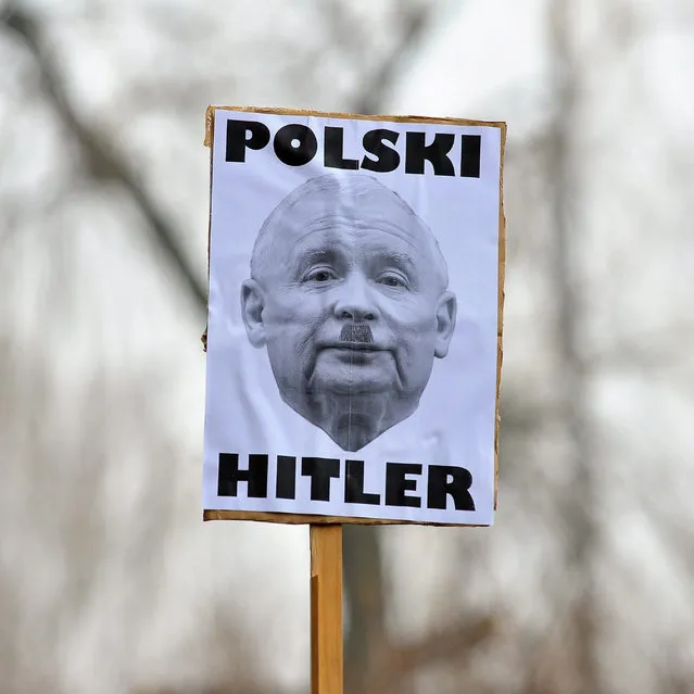 A man holds a placard with picture of Jaroslaw Kaczynski, with words reading “Polish Hitler”, during a protest in Bielsko-Biala, Poland December 18, 2016. (Photo by Agnieszka Morcineki/Reuters/Agencja Gazeta)