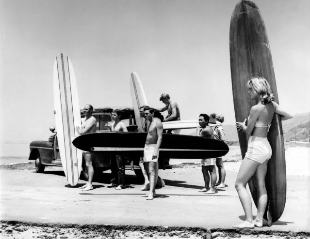 In this July 12, 1961 file photo members of the North Bay surfing club upload their surf boards from a station wagon at Malibu Beach, Calif, California Gov. Jerry Brown announced Monday, August 20, 2018 that he signed a bill making surfing the official state sport. (Photo by AP Photo)