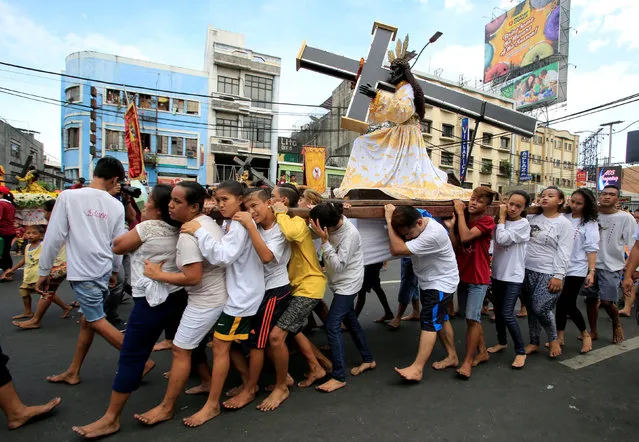 Barefoot devotees parade with replica of a Black Nazarene two days before the annual procession of the Black Nazarene in metro Manila, Philippines January 7, 2017. (Photo by Romeo Ranoco/Reuters)