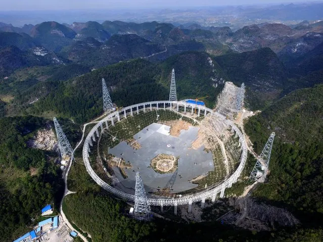 A picture made available 16 February 2016 shows the Five-hundred-meter Aperture Spherical radio Telescope (FAST) under construction in the remote Pingtang county in southwest China's Guizhou province, 26 November 2015. The project, one of China's nine most important scientific research facilities, will be the world's largest radio telescope upon completion by September 2016. (Photo by EPA/Stringer)