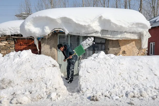 A man clears snow in front of his house during winter season in Yuksekova district of Hakkari, Turkey on January 22, 2019. (Photo by Ozkan Bilgin/Anadolu Agency/Getty Images)
