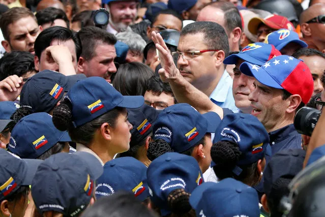 Venezuelan opposition leader and Governor of Miranda state Henrique Capriles (R) takes part in a rally against Venezuelan President Nicolas Maduro's government and to commemorate the 59th anniversary of the end of the dictatorship of Marcos Perez Jimenez in Caracas, Venezuela January 23, 2017. (Photo by Carlos Garcia Rawlins/Reuters)