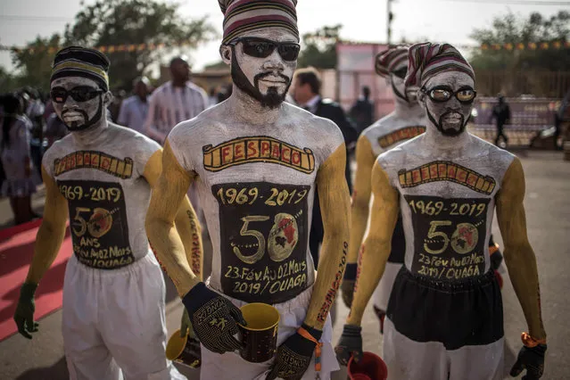 Performers arrive to the entrance of the venue where the opening ceremony of the FESPACO Panafrican Film and Television Festival of Ouagadougou is about to start, on February 23, 2019. Africa's biggest film festival marks its 50th anniversary, buoyed by its contributions to the continent's cinema industry but overshadowed by security problems in host country Burkina Faso. (Photo by Marco Longari/AFP Photo)