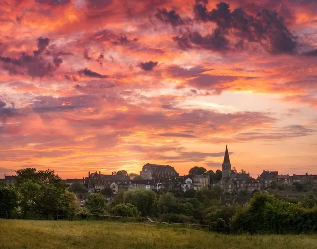 Before sunrise there is a “Turneresque” sky over the abbey at the picturesque Wiltshire, England market town of Malmesbury on June 11, 2023. (Photo by Terry Mathews/Alamy Live News)