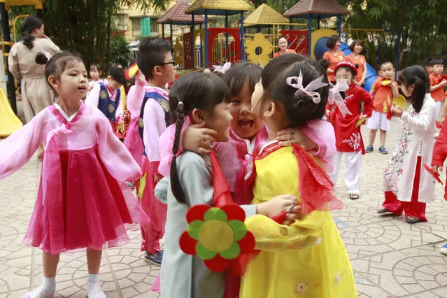 In this Thursday, February 21, 2019, photo, children in Vietnamese and Korean traditional costumes hug at each other at Vietnam-Korea Friendship Kindergarten in Hanoi, Vietnam. The children have been practicing singing and dancing, hoping to show off their talents to North Korean leader Kim Jong Un when he comes to town this week for his second summit meeting with U.S. President Donald Trump. (Photo by Hau Dinh/AP Photo)
