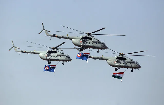 Helicopters of the Indian air force display Indian national flag and Indian air force flag during the Presidents' Standard Presentation (PSP) held at Jamnagar Air Force Station in the western state of Gujarat, India March 4, 2016. (Photo by Amit Dave/Reuters)
