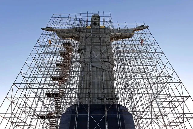 The statue of Christ the Redeemer is surrounded by scaffolding during the 2010 renovations. (Photo by Felipe Dana/Associated Press)