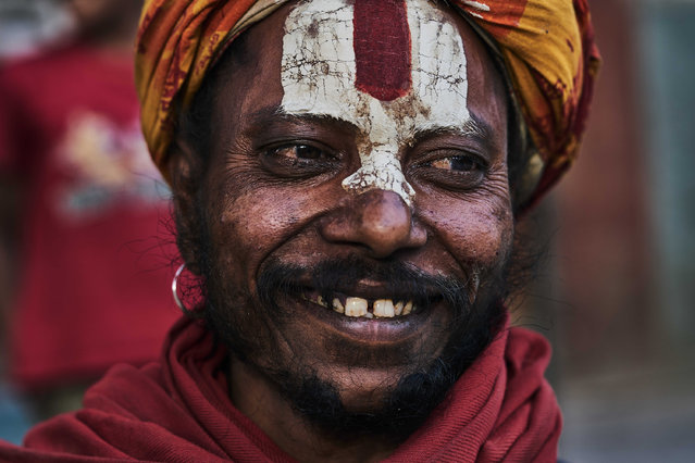 A holy man with a paint face smiles, taken in Kathmandu, Nepal. (Photo by Jan Moeller Hansen/Barcroft Images)