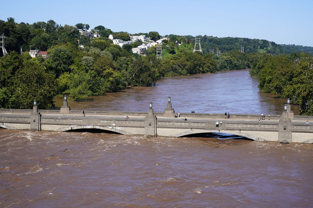 The Schuylkill River exceeds its bank in the Manayunk section of Philadelphia, Thursday, September 2, 2021 in the aftermath of downpours and high winds from the remnants of Hurricane Ida that hit the area. (Photo by Matt Rourke/AP Photo)
