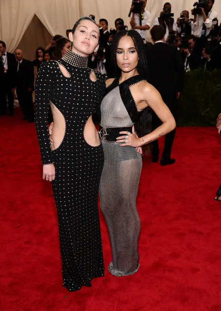 Miley Cyrus, left, and  Zoe Kravitz arrive at The Metropolitan Museum of Art's Costume Institute benefit gala celebrating “China: Through the Looking Glass” on Monday, May 4, 2015, in New York. (Photo by Charles Sykes/Invision/AP Photo)