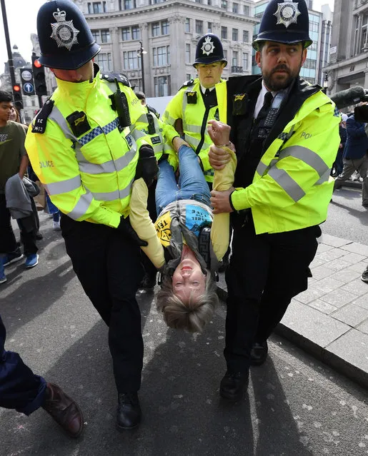 Police officers arrest activists during Extinction Rebellion climate change protests on Oxford Circus in London, Britain, 18 April 2019. The Waterloo Bridge remains closed as protests continue. (Photo by Facundo Arrizabalaga/EPA/EFE)