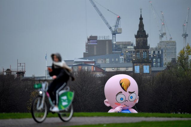 A giant baby balloon inflated by Climate Change activists is seen in the rain at Glasgow Green as the UN Climate Change Conference (COP26) takes place, in Glasgow, Scotland, Britain, November 8, 2021. (Photo by Dylan Martinez/Reuters)