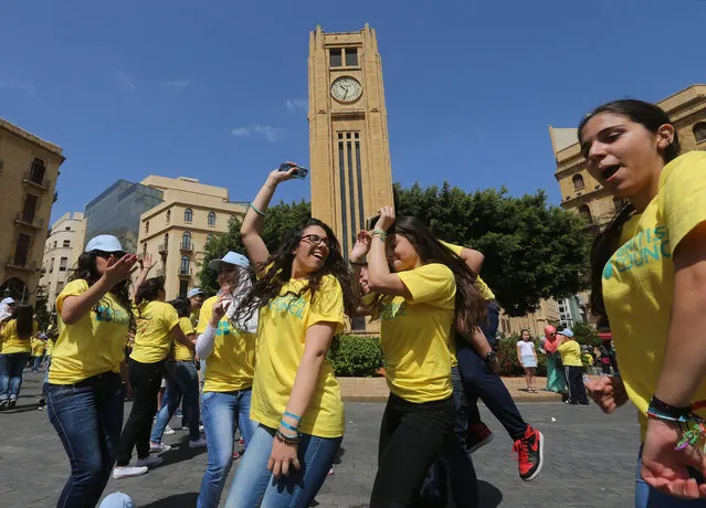 Lebanese students dance during the event The Big Dance “Beats for Peace”, at the Parliament square, in downtown Beirut, Lebanon, Saturday, May 9, 2015. (Photo by Hussein Malla/AP Photo)