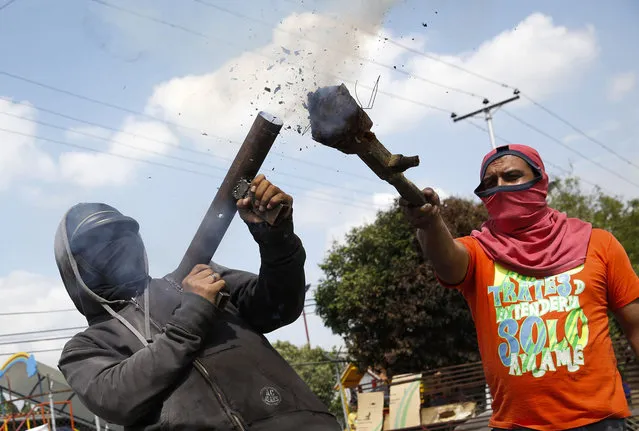 An opposition demonstrator shoots a rudimentary mortar during a protest against President Nicolas Maduro's government in Rubio outside San Cristobal, about 410 miles (660 km) southwest of Caracas, February 27, 2014. (Photo by Carlos Garcia Rawlins/Reuters)