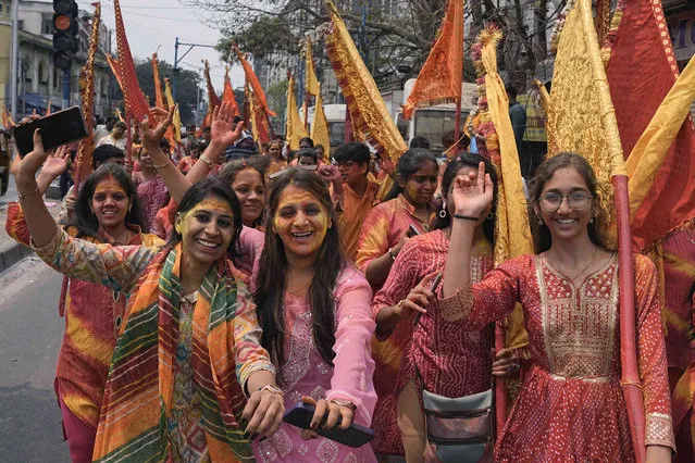Women dance as they participate in a procession to mark Falgun Mahotsav ahead of Holi, the Hindu festival of colors, in Hyderabad, India, Wednesday, March 20, 2024. (Photo by Mahesh Kumar A./AP Photo)