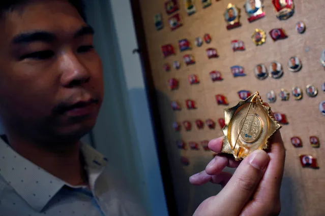 Thomas Hui displays an Order of Kim Il Sung badge, the top order in North Korea, with a smudge at the back which may suggest a scrapped serial number, at his apartment in Hong Kong, China April 11, 2016. (Photo by Bobby Yip/Reuters)