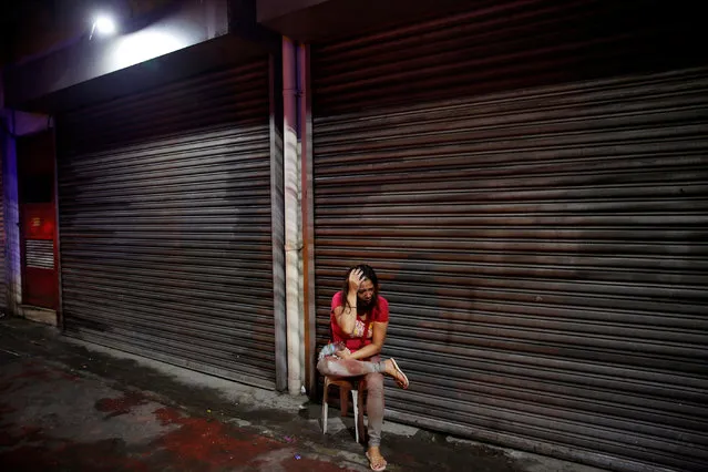 A woman covered in blood holds her head after her husband was shot dead by unidentified gunmen riding motorcycles in Manila, Philippines late October 10, 2016. (Photo by Damir Sagolj/Reuters)