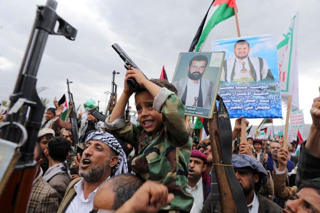 A child holds a pistol as demonstrators, predominantly Houthi supporters, rally to show support to the Palestinians in the Gaza Strip, amid the ongoing conflict between Israel and the Palestinian Islamist group Hamas, in Sanaa, Yemen on February 16, 2024. (Photo by Khaled Abdullah/Reuters)