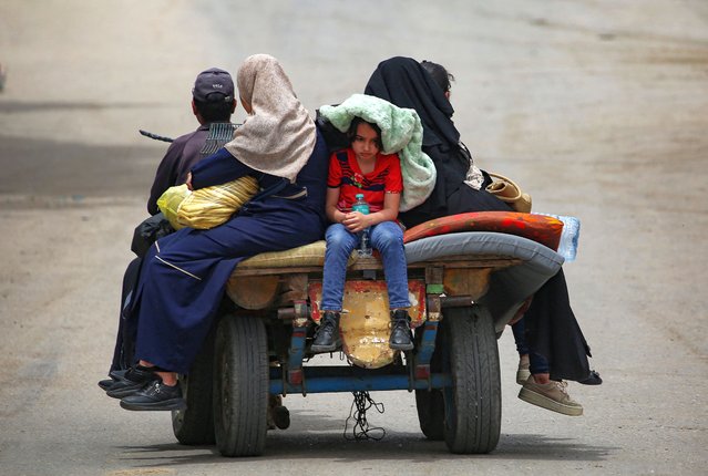 Palestinians sit on an animal pulled cart as they move to safer areas in Rafah, in the southern Gaza Strip, on May 10, 2024, amid the ongoing conflict between Israel and the militant group Hamas. (Photo by AFP Photo/Stringer)