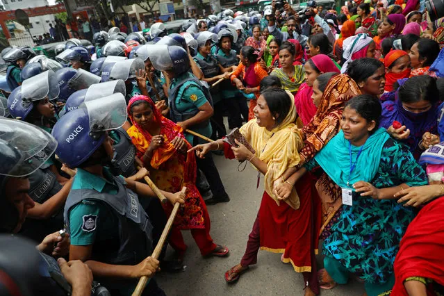 Garment workers react during clashes with police at a protest demanding for arrears in Dhaka, Bangladesh, September 12, 2019. (Photo by Mohammad Ponir Hossain/Reuters)