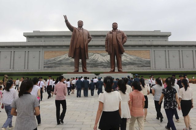 People visit Mansu Hill to pay respect to the statues of former leaders, Kim Il Sung, left, and Kim Jong Il on the occasion of the 30th anniversary of demise of Kim Il Sung, in Pyongyang, North Korea, Sunday, July 7, 2024. (Photo by Jon Chol Jin/AP Photo)