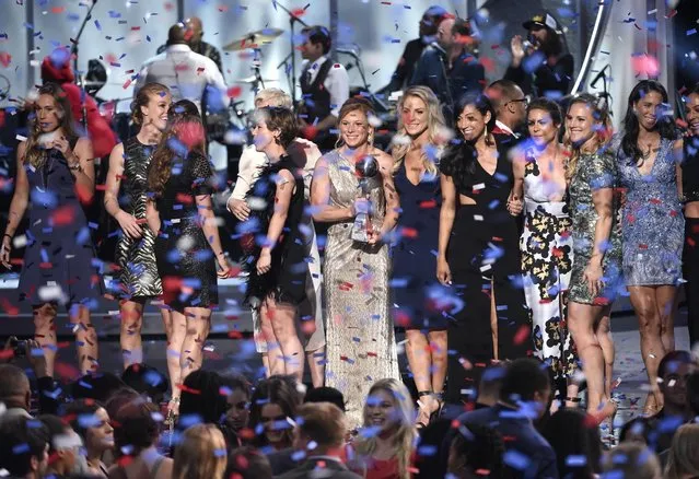 Members of the U.S. women's national soccer team celebrate on stage after  accepting the best team award at the ESPY Awards at the Microsoft Theater on Wednesday, July 15, 2015, in Los Angeles. (Photo by Chris Pizzello/Invision/AP Photo)