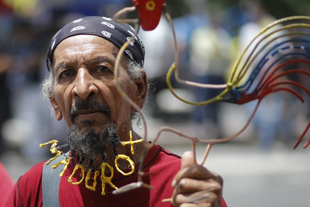 A supporter of Venezuelan President Nicolas Maduro features the president's name woven into his beard as he waits for the start of the president's closing campaign rally as he seeks reelection in Caracas, Venezuela, Thursday, July 25, 2024. The presidential election is set for July 28. (Photo by Cristian Hernandez/AP Photo)