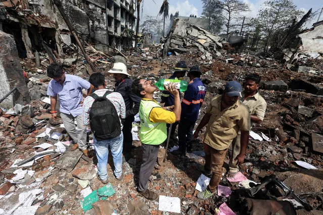 People inspect the damages after a blast in a chemical factory in Dombivali, on the outskirts of Mumbai, India, 26 May 2016. (Photo by Divyakant Solanki/EPA)