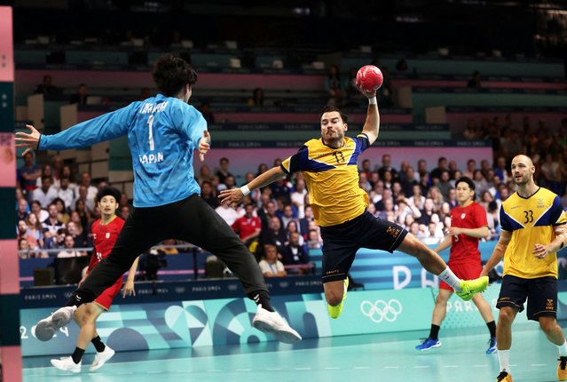 Sebastian Karlsson of Sweden in action with Takumi Nakamura of Japan during Sweden vs Japan in men's preliminary round group A handball on August 4, 2024. (Photo by Eloisa Lopez/Reuters)