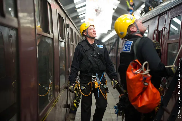 Police take part in a role play exercise as they clear a protest on top of a train during training in Oxenhope, England