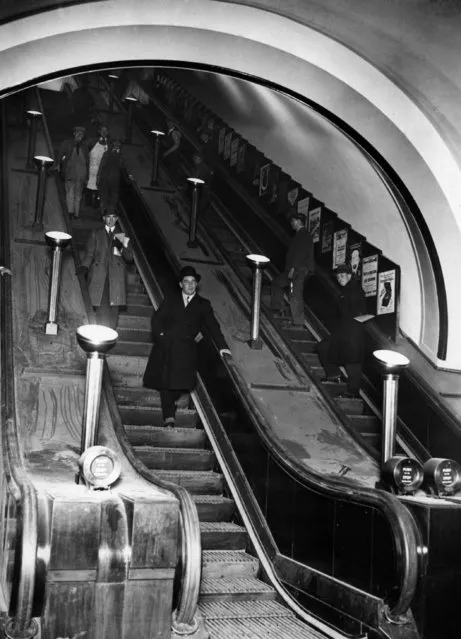 Passengers on the giant escalators at the newly opened Piccadilly Underground Station, London, designed by Charles Holden, 1928. (Photo by Topical Press Agency/Getty Images)