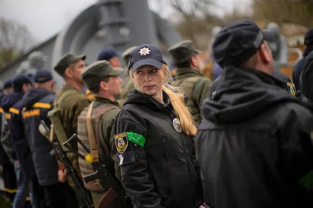 Decorated State Emergency Service units member Anna Pinchuk attends a ceremony commemorating the Chernobyl nuclear power plant disaster, at the Those Who Saved the World monument in Chernobyl, Ukraine, Tuesday, April 26, 2022. (Photo by Francisco Seco/AP Photo)