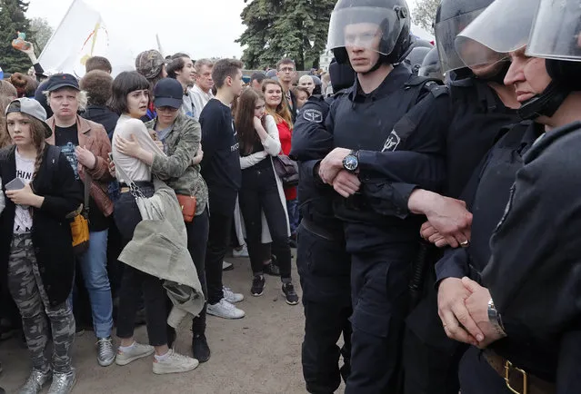 Russian police officers face participants of an unauthorized anti-corruption rally at the Marsovo Field on Russia Day in central St. Petersburg, Russia, 12 June 2017. Russian liberal opposition leader and anti-corruption blogger Alexei Navalny has called his supporters to hold a protest in many Russian cities. According to news reports citing his wife Yuliya Navalnaya, Alexei Navalny has been arrested ahead of planned protests in Moscow. (Photo by Anatoly Maltsev/EPA)
