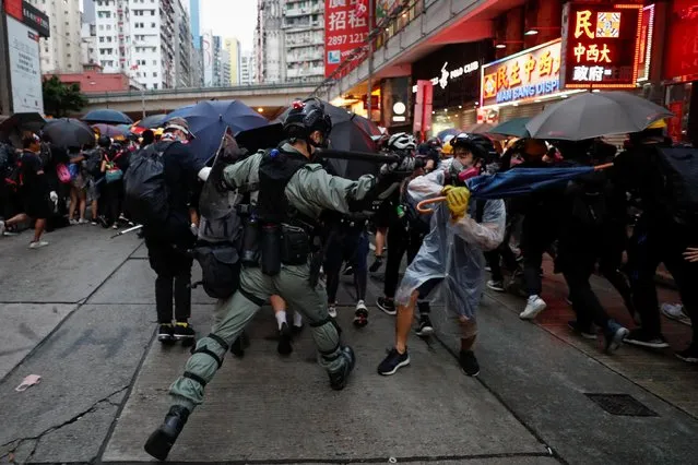 A riot police officer clashes with a protester during an anti-government rally in central Hong Kong, China on October 6, 2019. (Photo by Jorge Silva/Reuters)