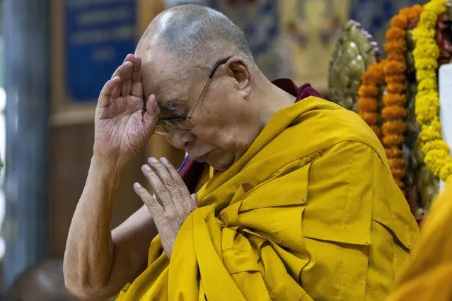 Tibetan spiritual leader the Dalai Lama gestures during a prayer session in Dharmsala, India, Wednesday, May 25, 2022. Monks of the Sakya lineage of the Tibetan Buddhism prayed for the long life of the Dalai Lama. (Photo by Ashwini Bhatia/AP Photo)