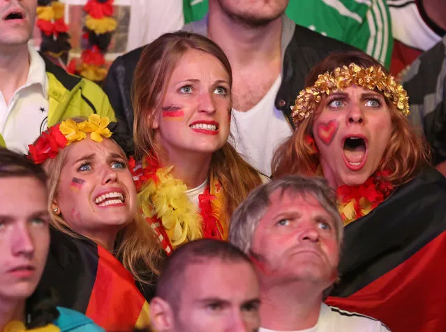 Fans of Germany watch the 2014 FIFA World Cup final match between Germany and Argentina at the Fanmeile public viewing at Brandenburg Gate on July 13, 2014 in Berlin, Germany. (Photo by Matthias Kern/Bongarts/Getty Images)