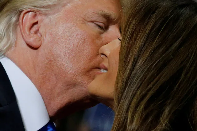 U.S. President Donald Trump kisses first lady Melania Trump after she introduced him at a rally with supporters in an arena in Youngstown, Ohio, U.S. July 25, 2017. (Photo by Jonathan Ernst/Reuters)