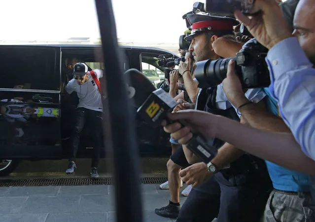 Soccer player Neymar arrives at the Barcelona airport in Prat de Llobregat, Spain, Friday, August 4, 2017. The Brazil star became the most expensive player in soccer history after completing his blockbuster transfer from Barcelona for 222 million euros ($262 million) on Thursday. By paying the release clause in his contract, PSG shattered the world transfer record to sign arguably one of the top three best attacking players in the game, alongside Lionel Messi and Cristiano Ronaldo. (Photo by Manu Fernandez/AP Photo)