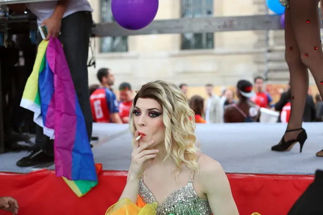 A reveler smokes during the annual Gay Pride march in Paris, France, Saturday, July 2, 2016. (Photo by Thibault Camus/AP Photo)