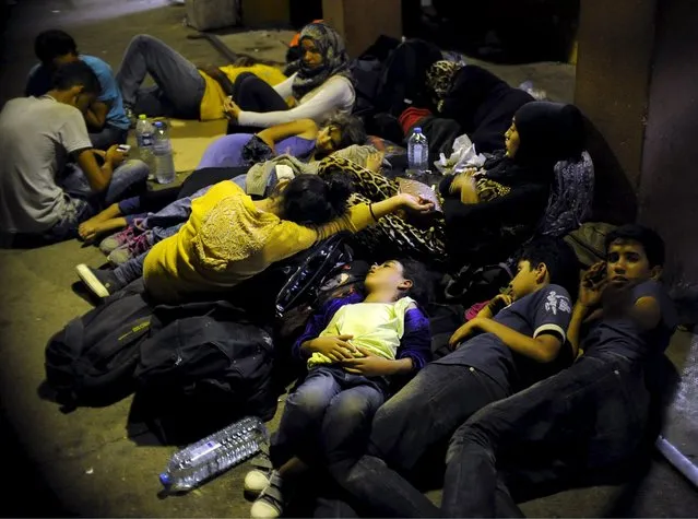 Immigrants sleep at Gevgelija railway station, Macedonia August 19, 2015. (Photo by Ognen Teofilovski/Reuters)